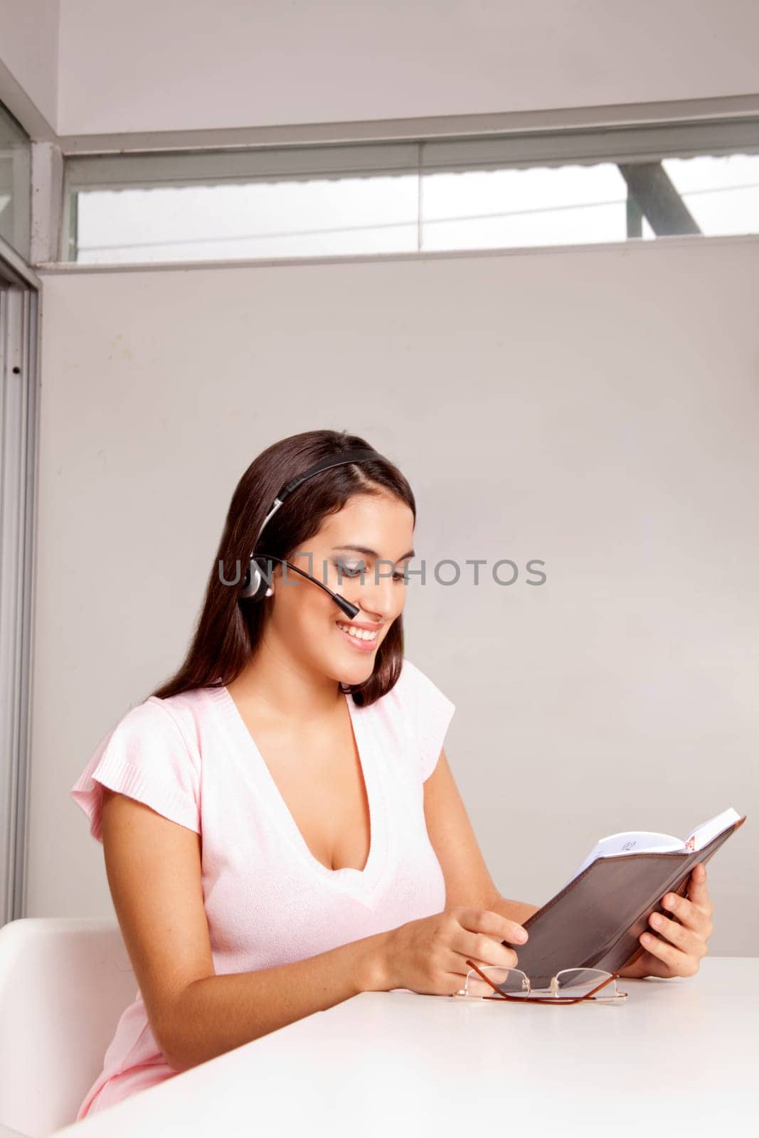 A woman in an office talking on the phone in a business call