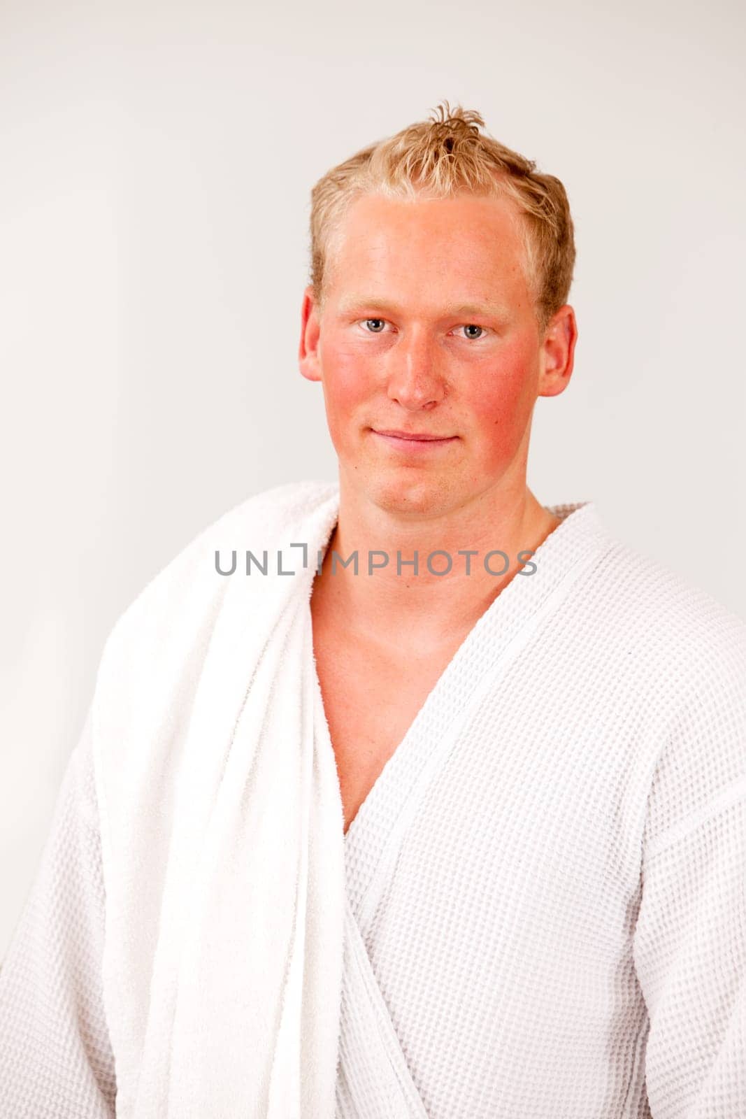 A portrait of a content man wearing a bathrobe