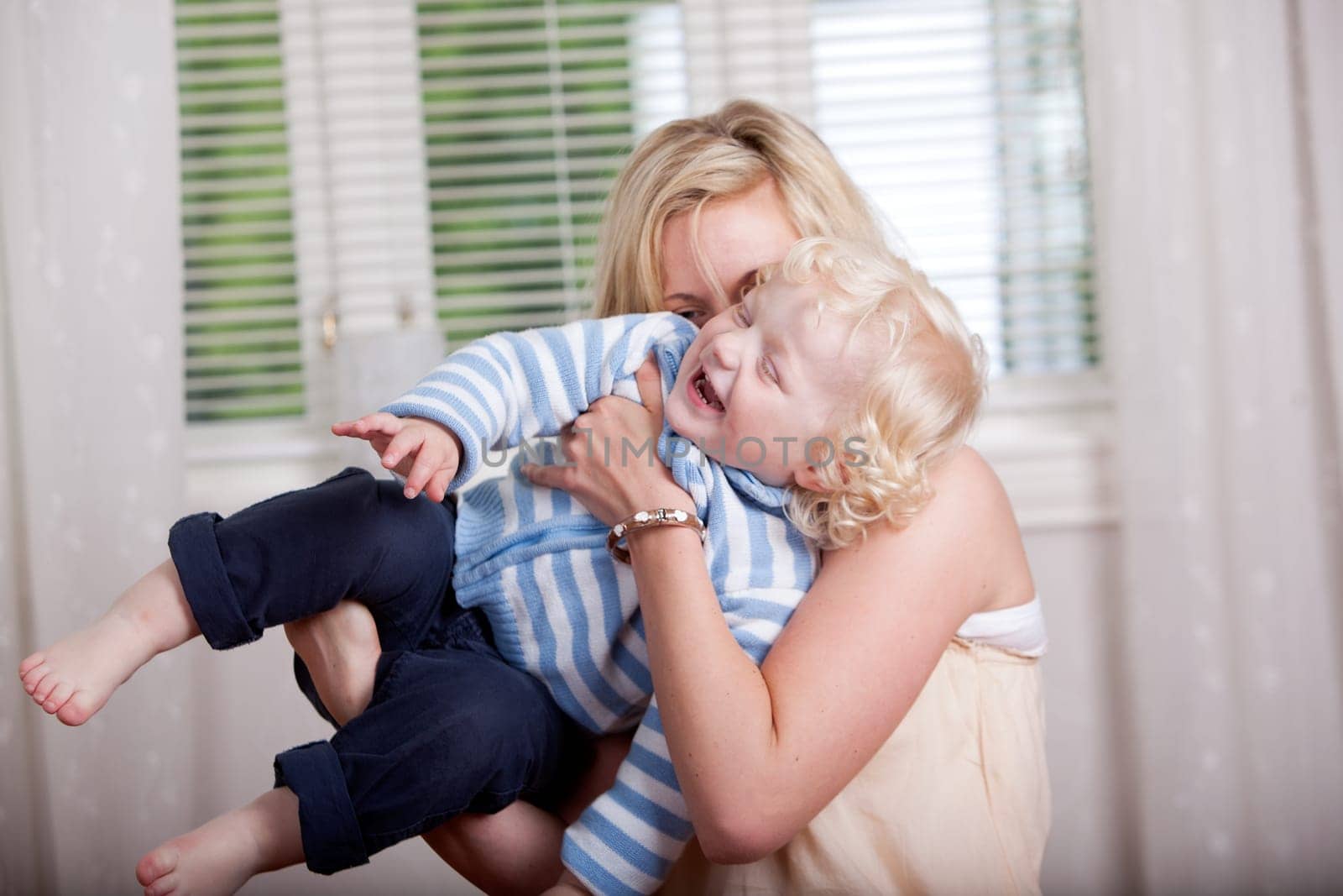 Portrait of a mother and son laughing and joking together