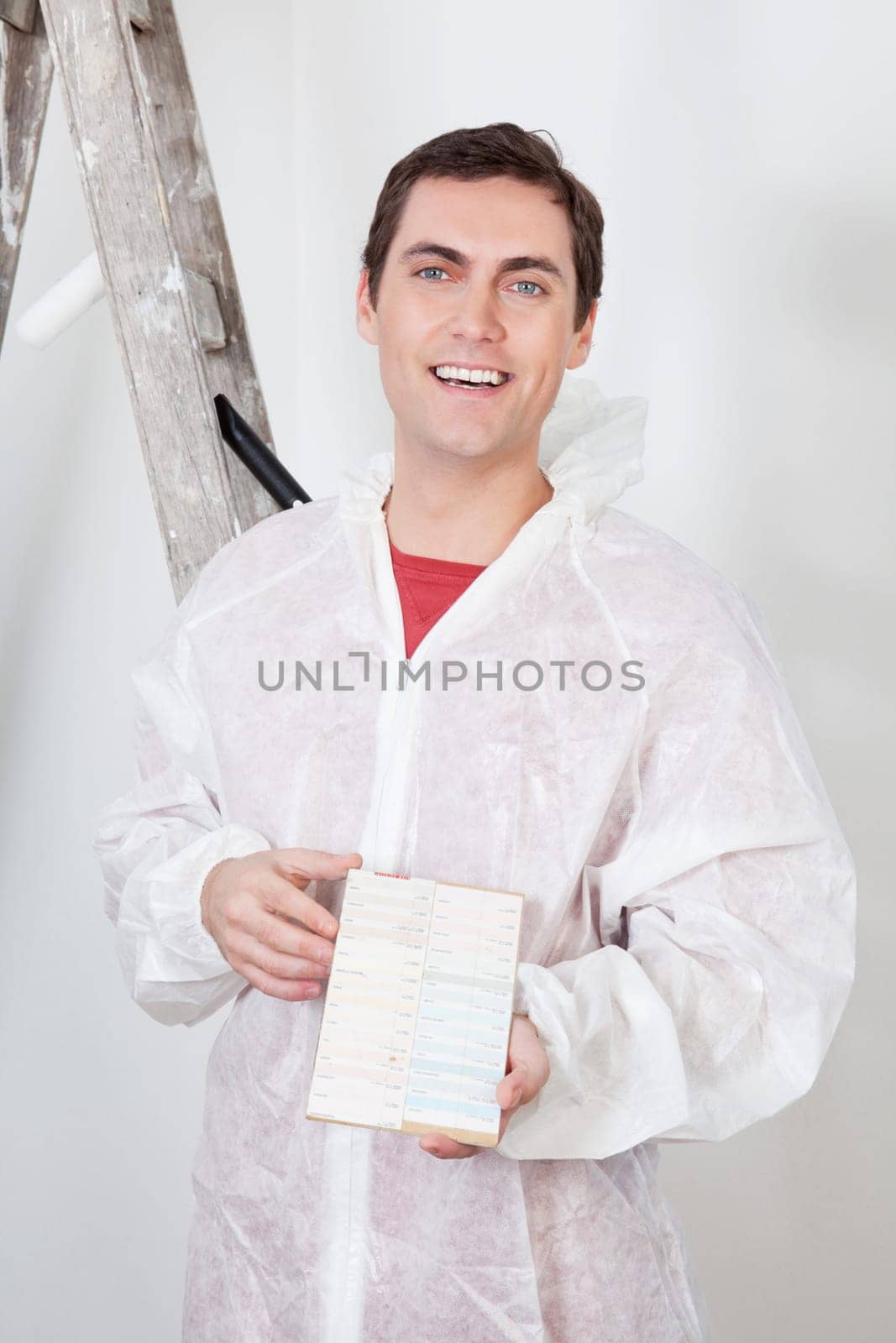 Portrait of a smiling workman showing the color swatch