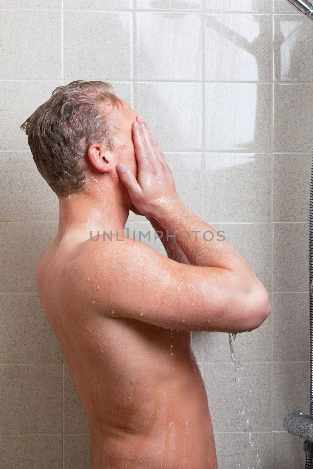 Mature man having bath in the bathroom