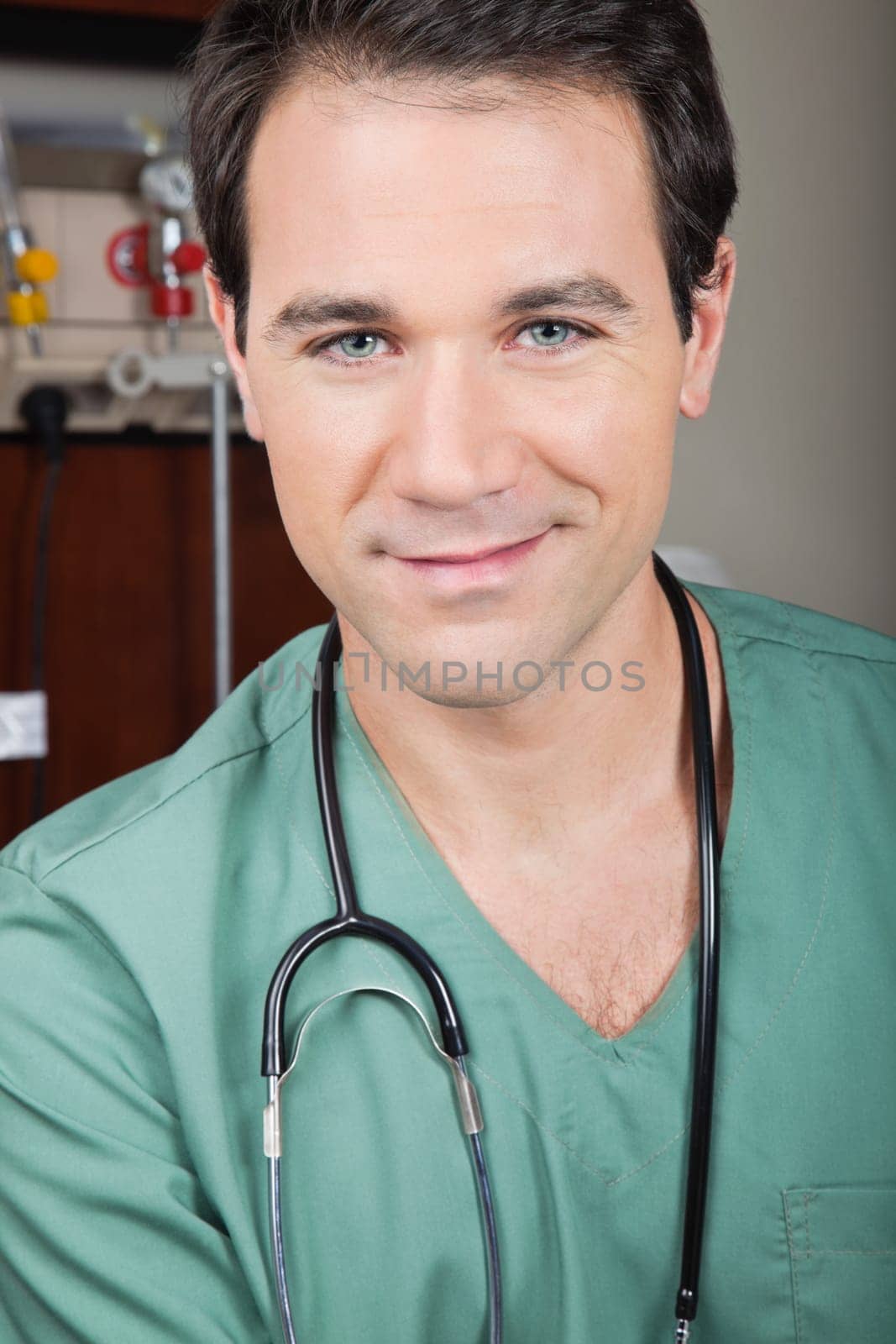 Portrait of handsome male surgeon smiling