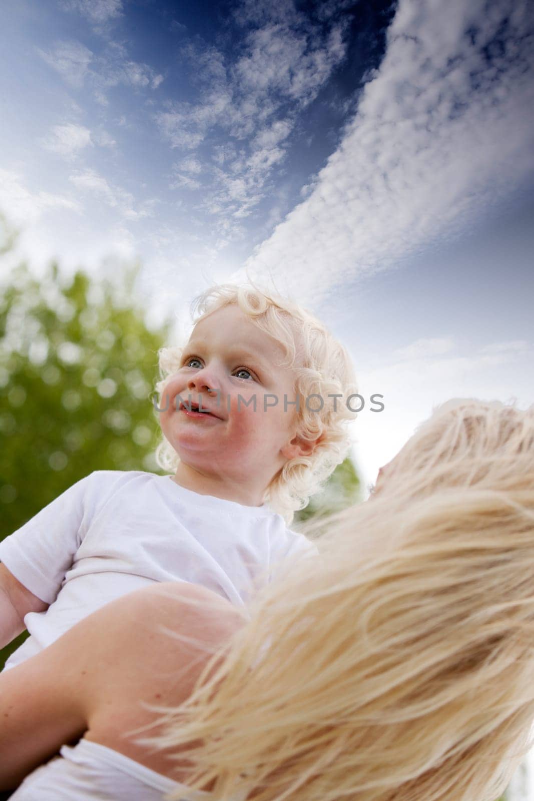 A mother comforting her son in an outdoor setting.
