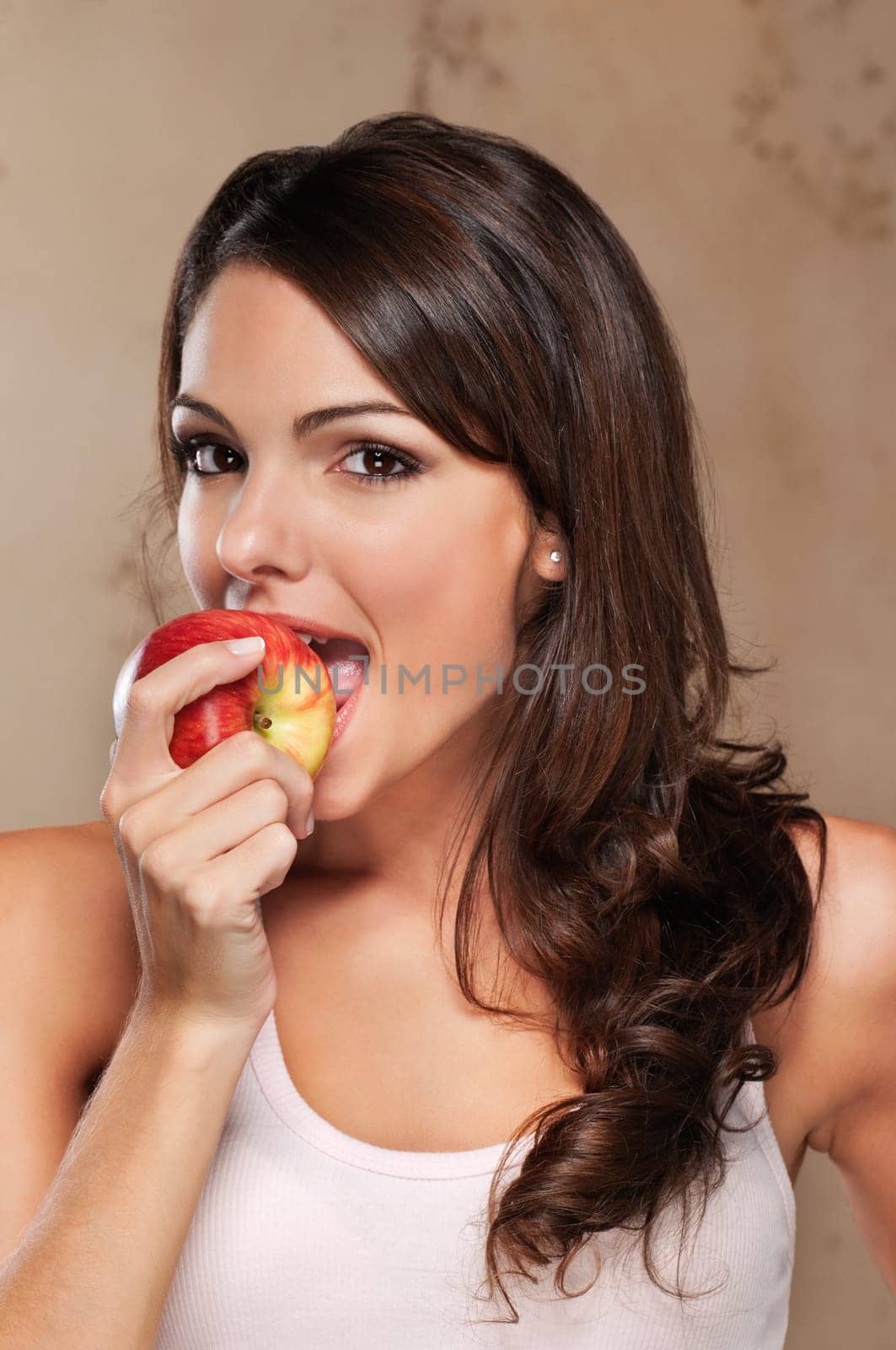 Close-up portrait of an attractive female eating an apple