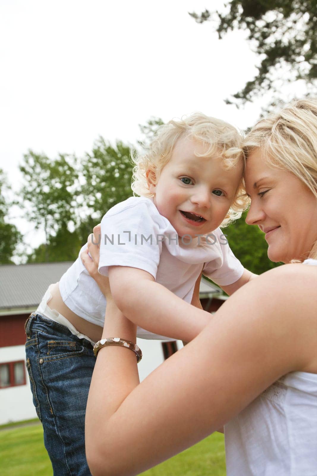 Smiling young mother holding her adorable baby
