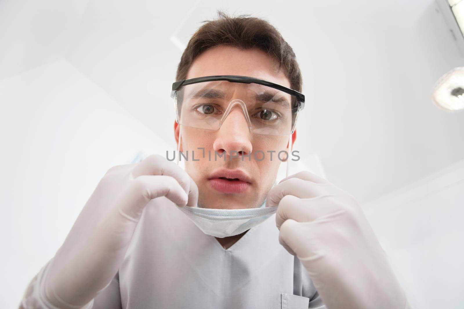 Close-up of young male dentist wearing mask