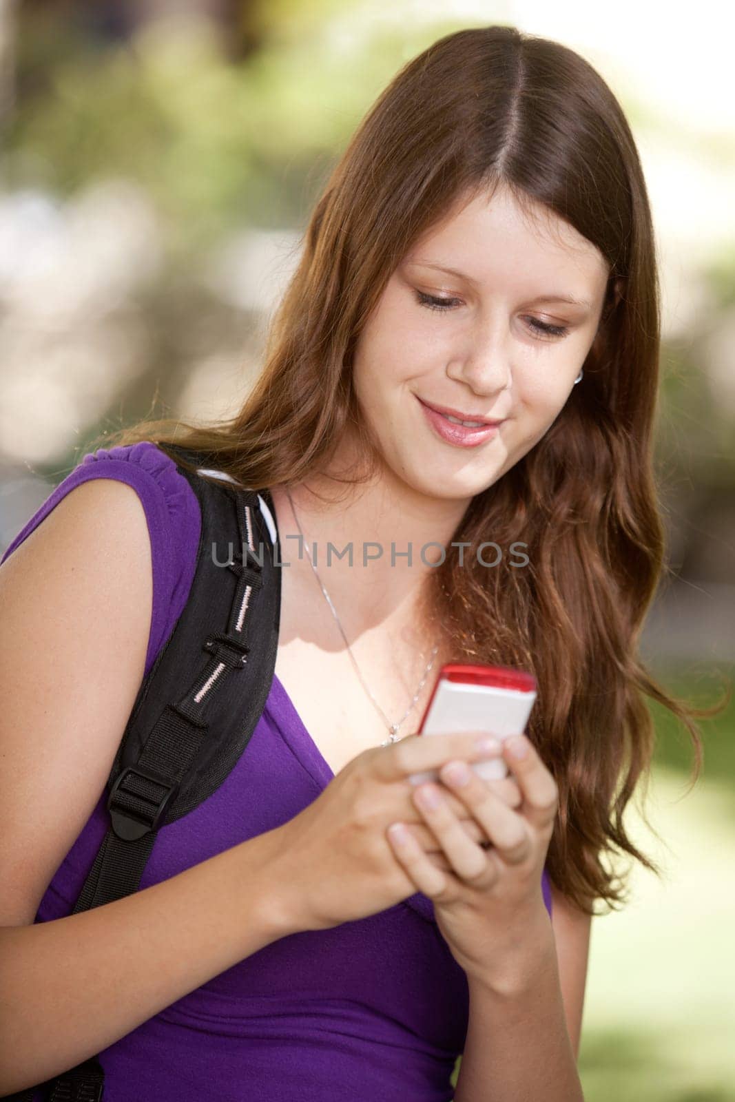 Student looking at cell phone and texting