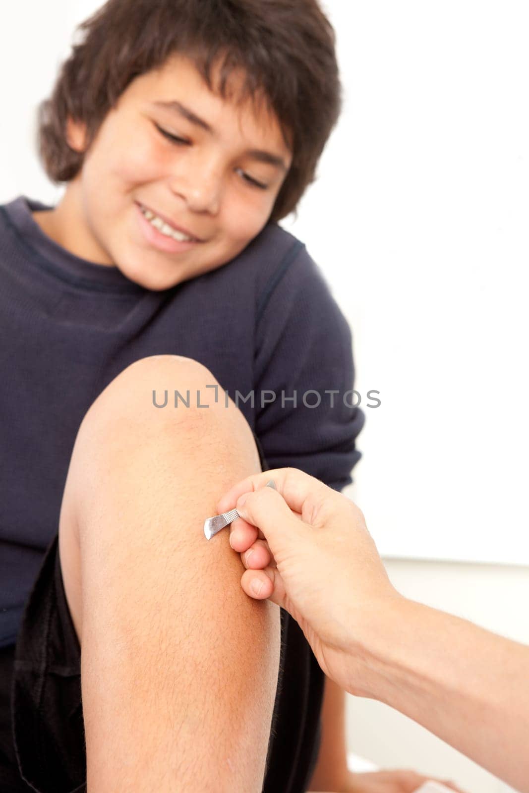 Shonishin acupuncture tool being used on a young male patient.  Shallow depth of field, focus on choto tool