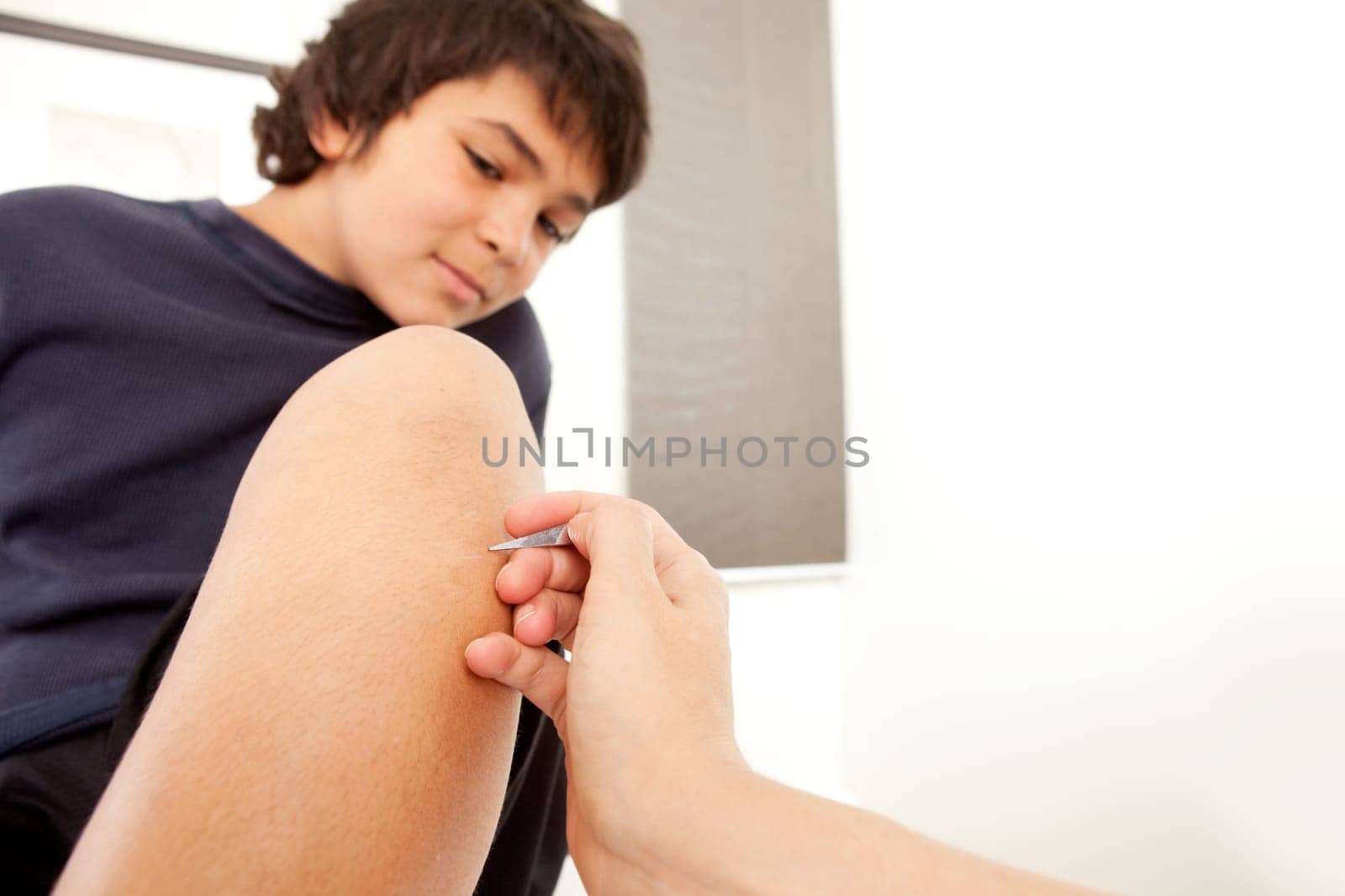 Young male receiving Japanese Shonishin acupuncture treatment with heragata spear.