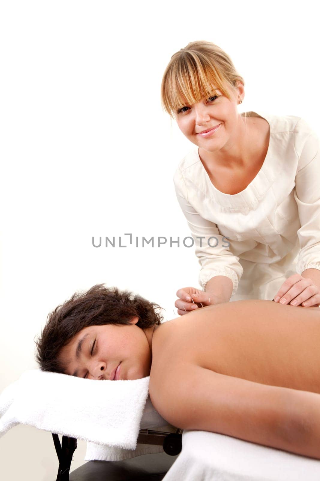 Portrait of a young male receiving acupuncture treatment