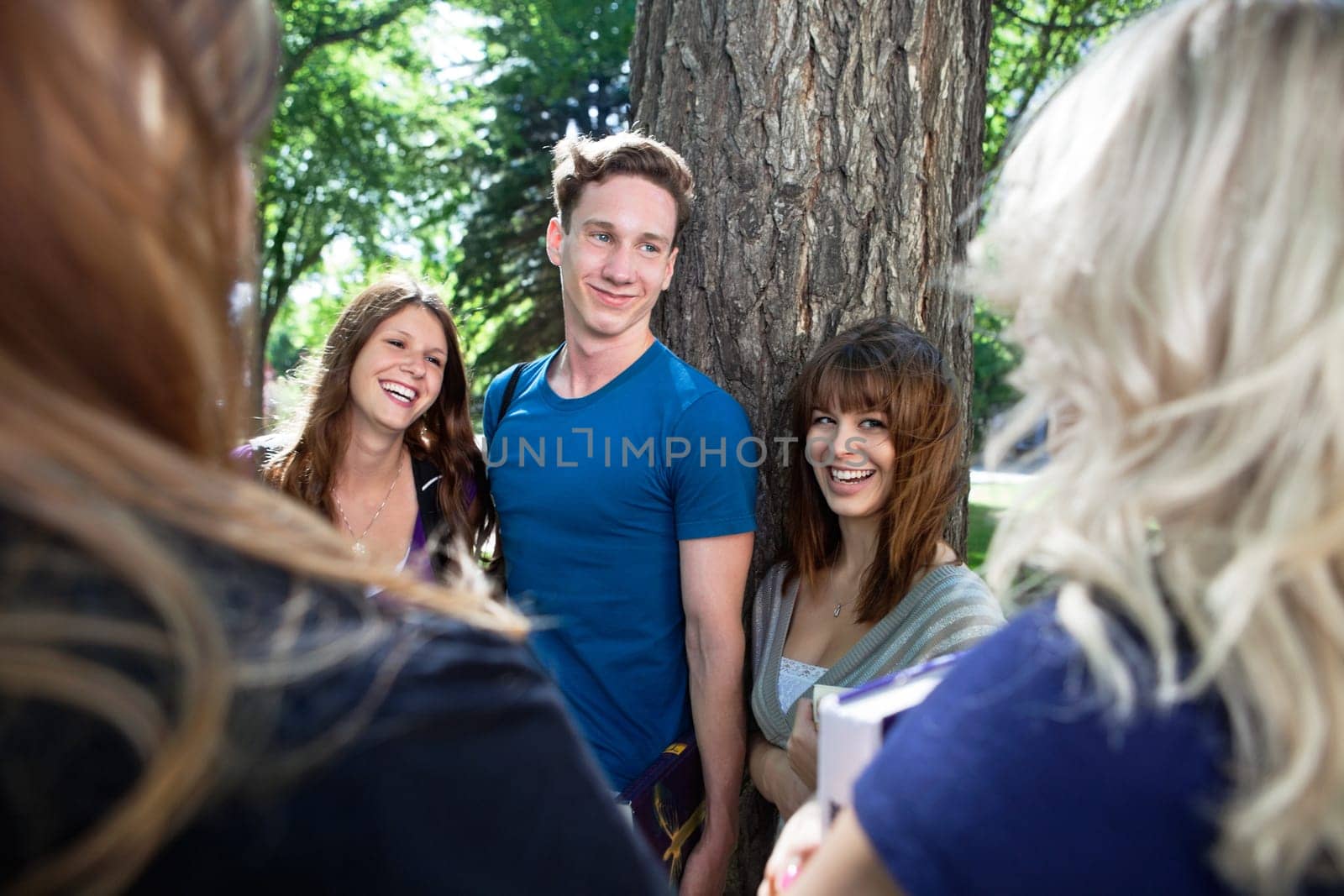 Group of happy college students having great time together