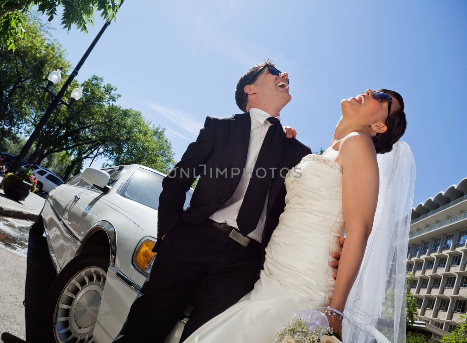 Happy newly wed couple in sunglasses
