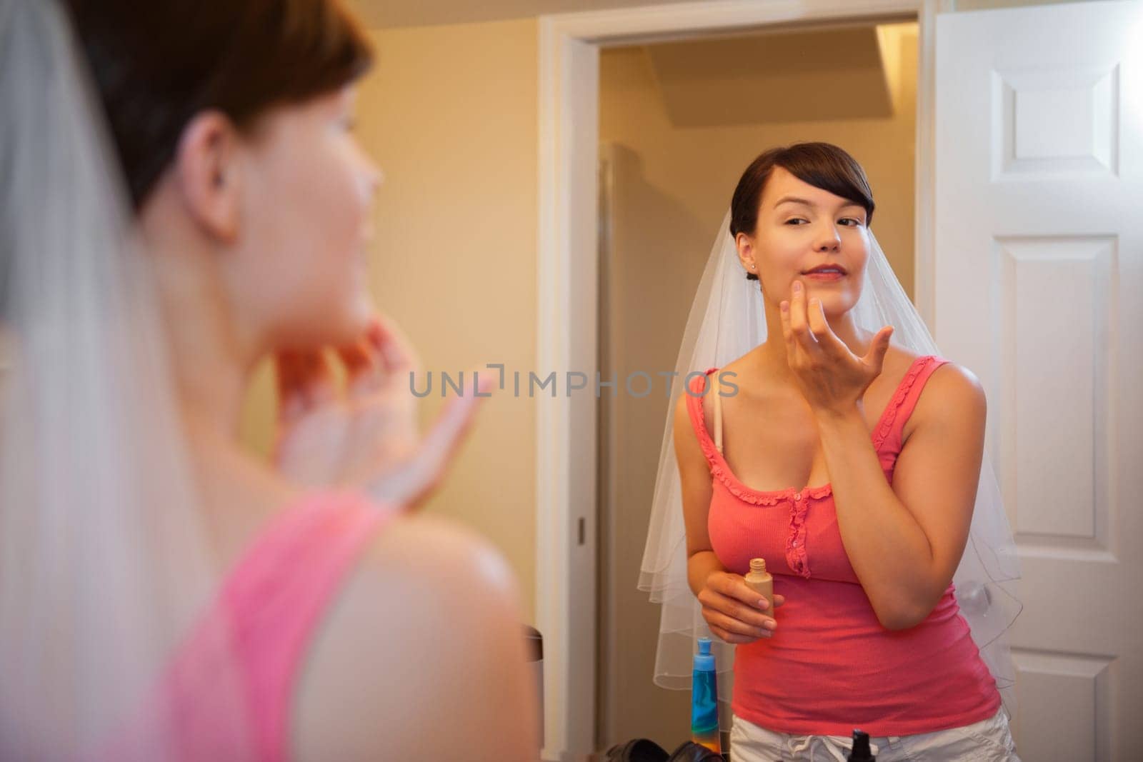 Bride getting ready for wedding, applying make-up