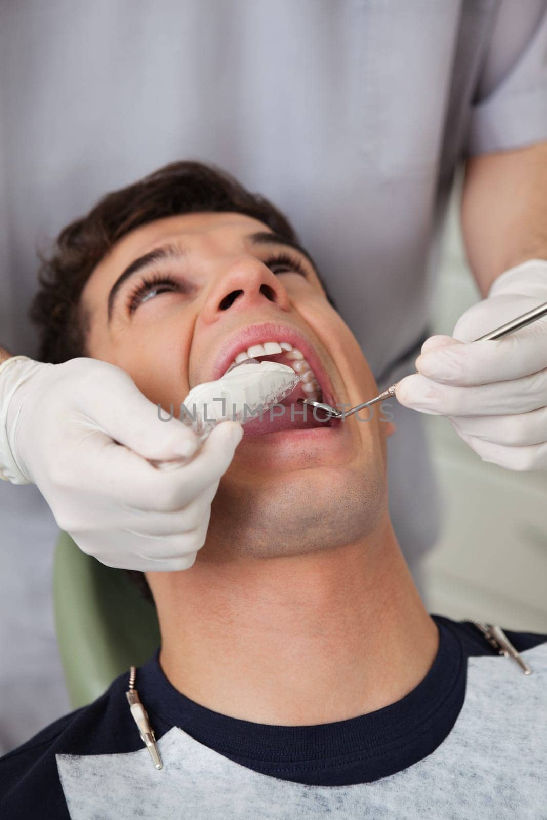 Dentist putting in molds in patients mouth