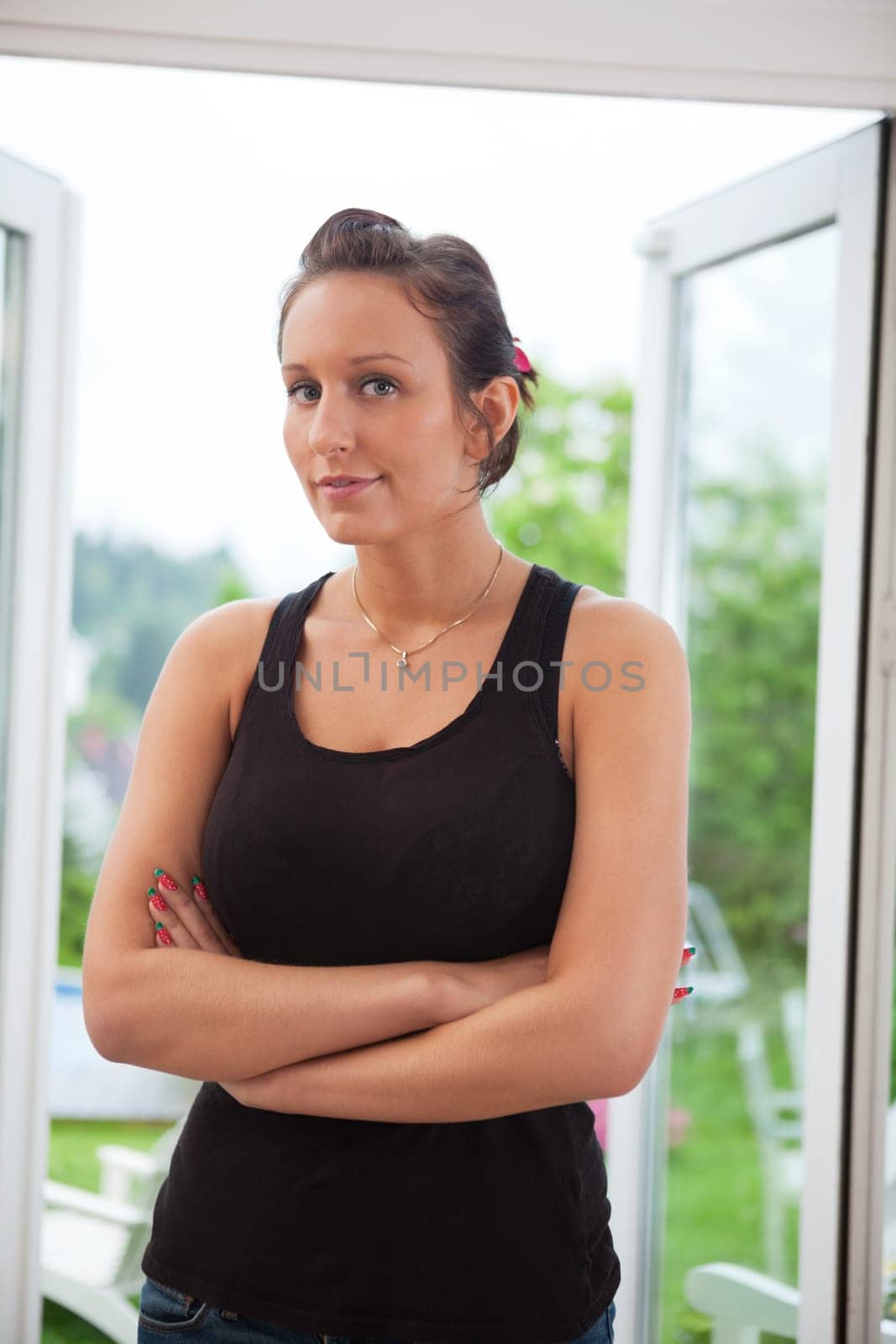 Portrait of attractive young female standing with hands folded