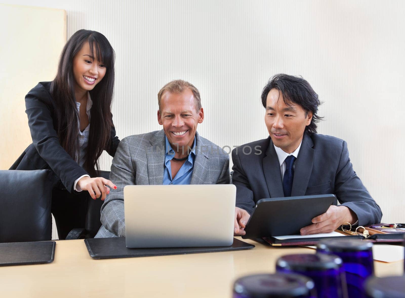 Group of diverse colleagues working on laptop