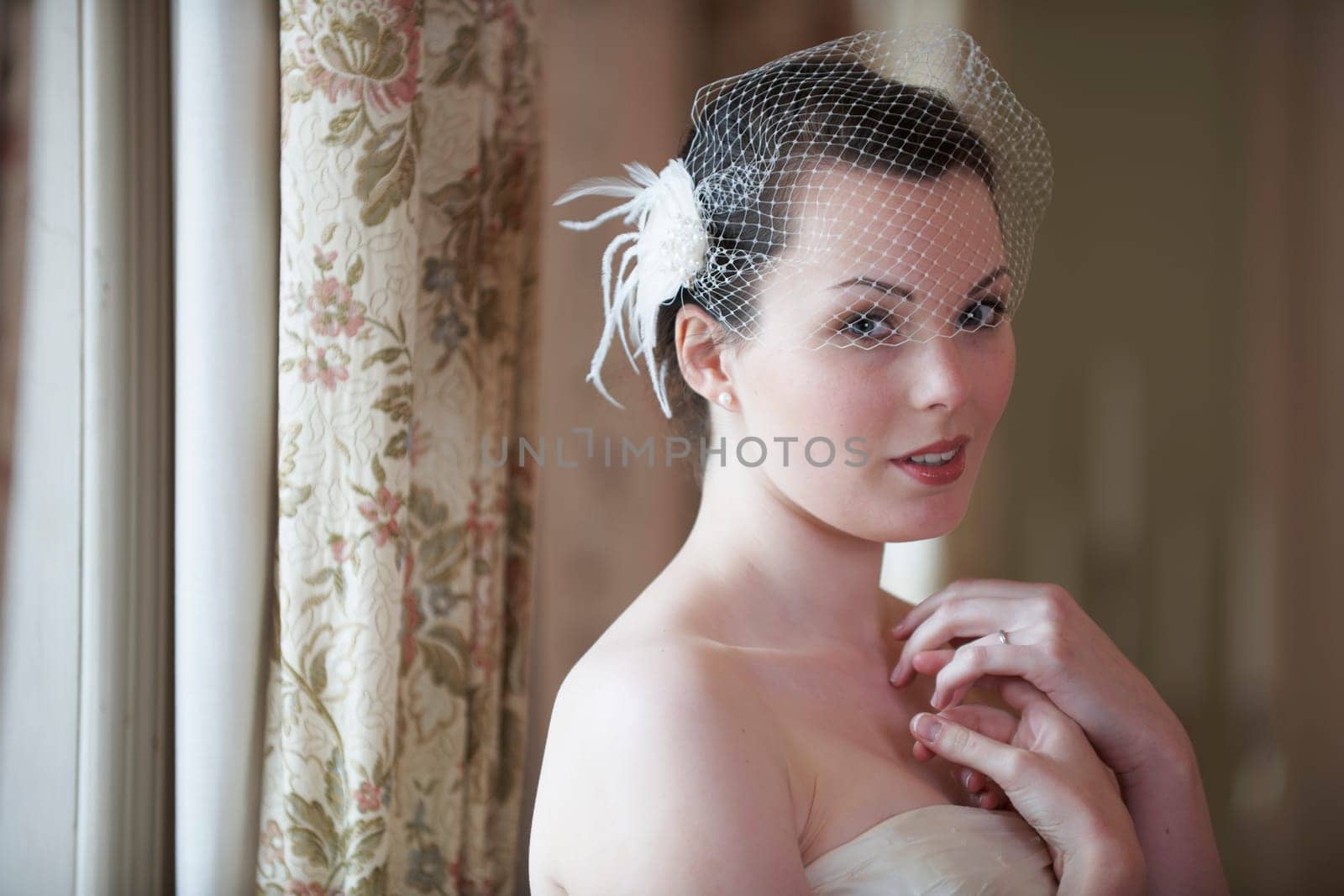 Pretty bride looking at camera and smiling on her wedding day