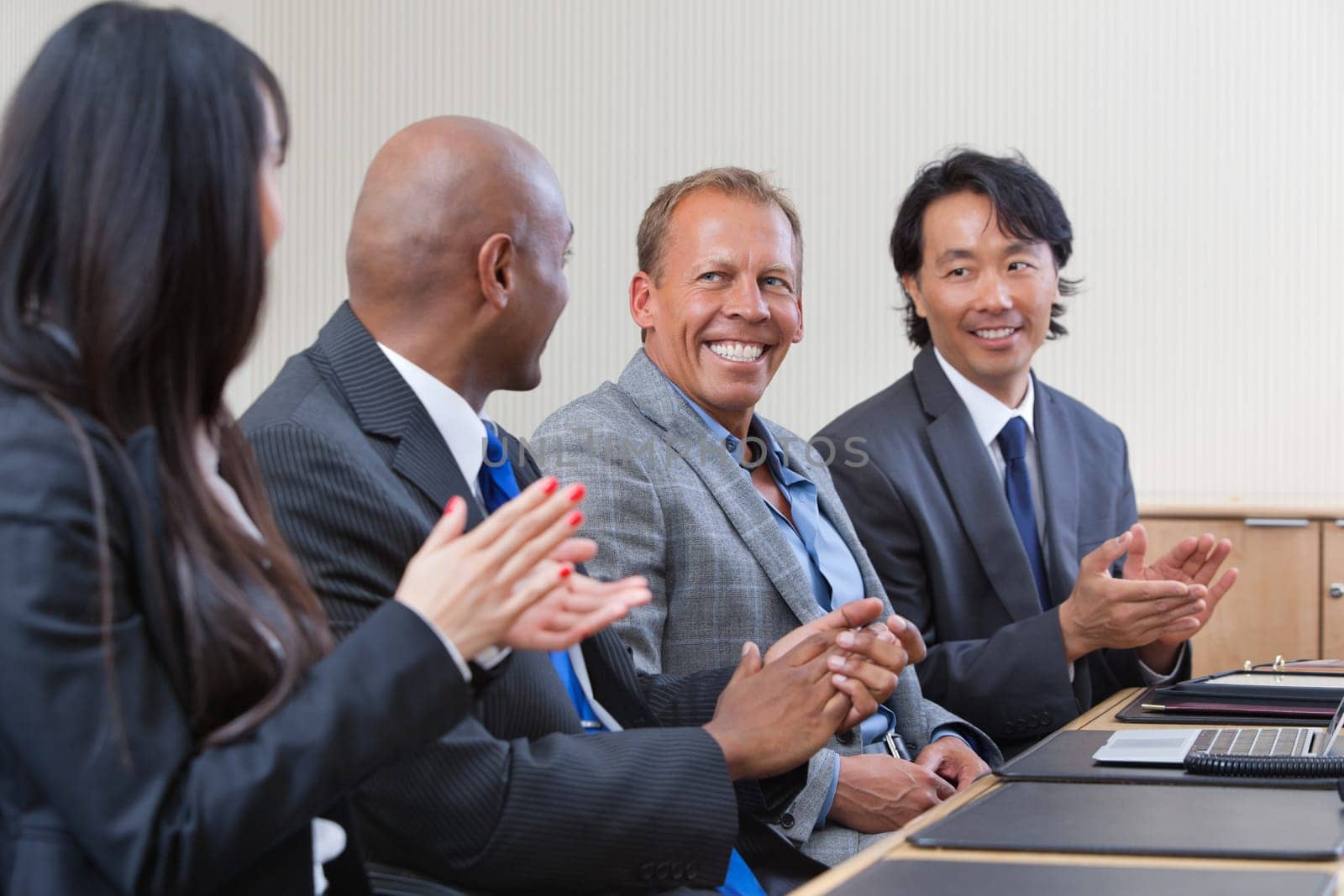 Professionals applauding during a business meeting