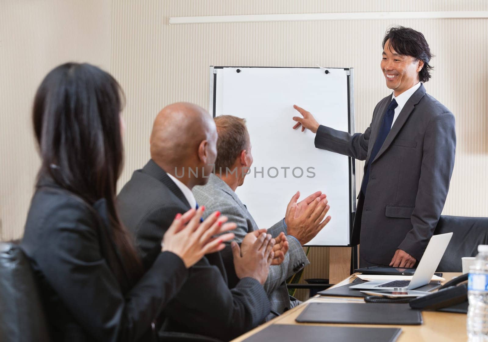 People giving applause after speech of a businessman at the conference