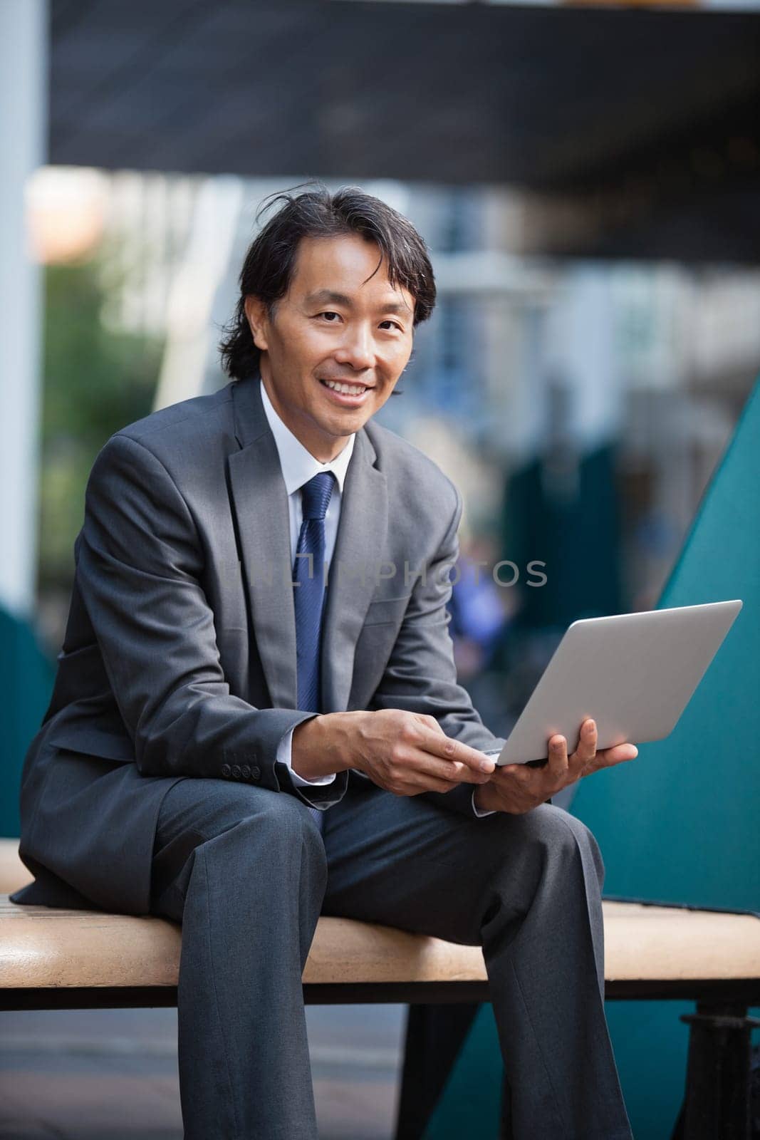 Portrait of an Asian businessman using laptop