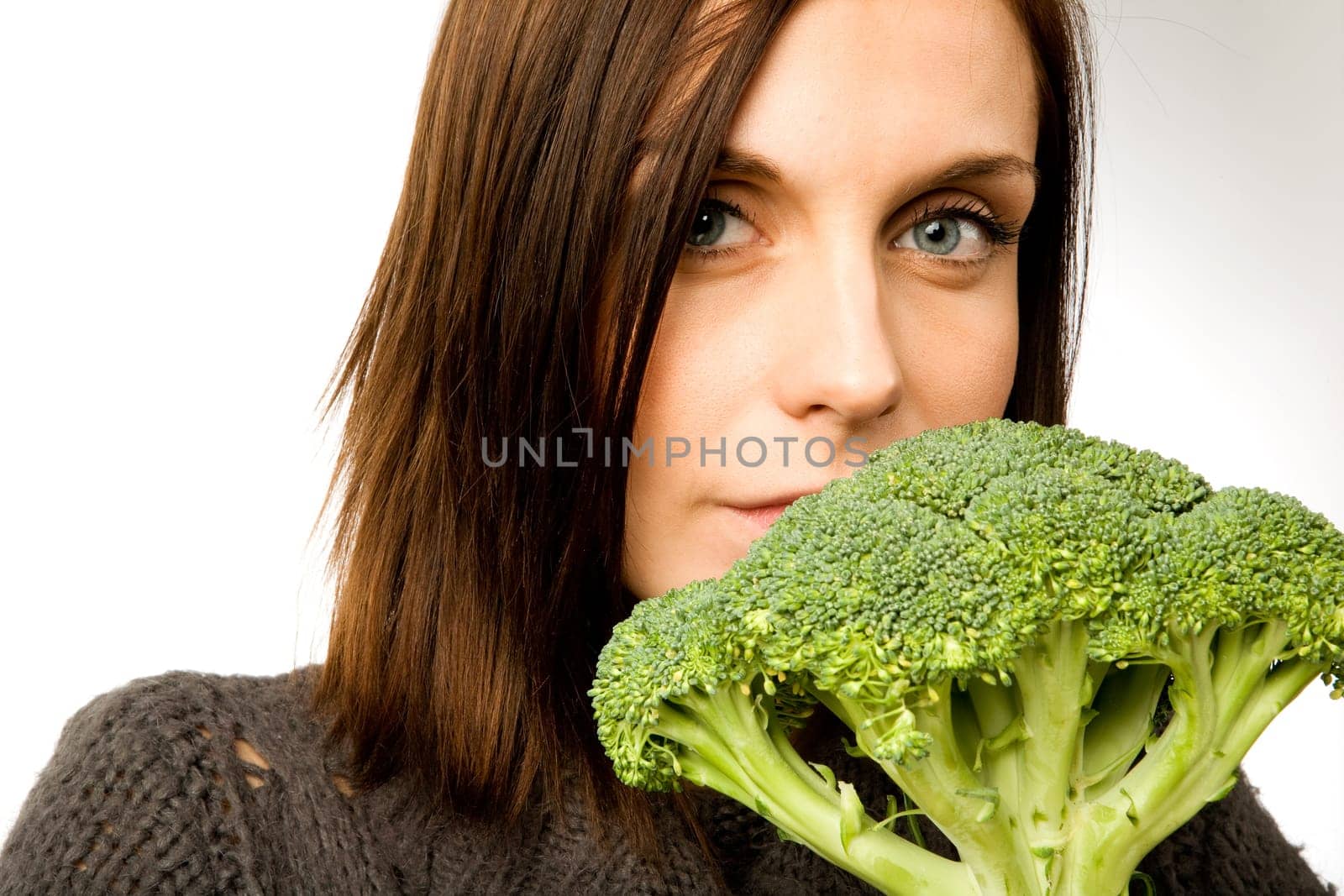A woman with broccoli in hand