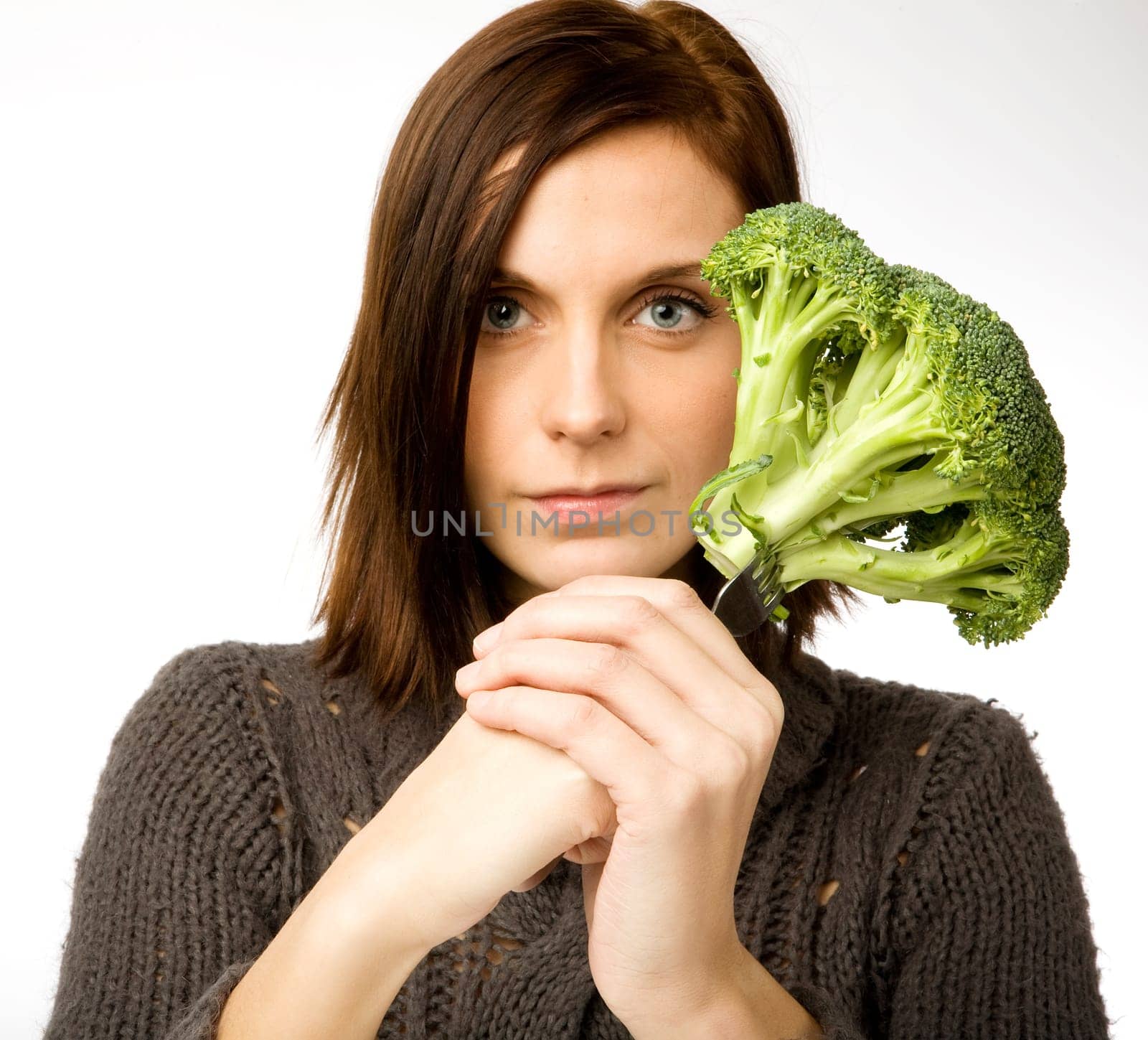 A woman with broccoli in hand