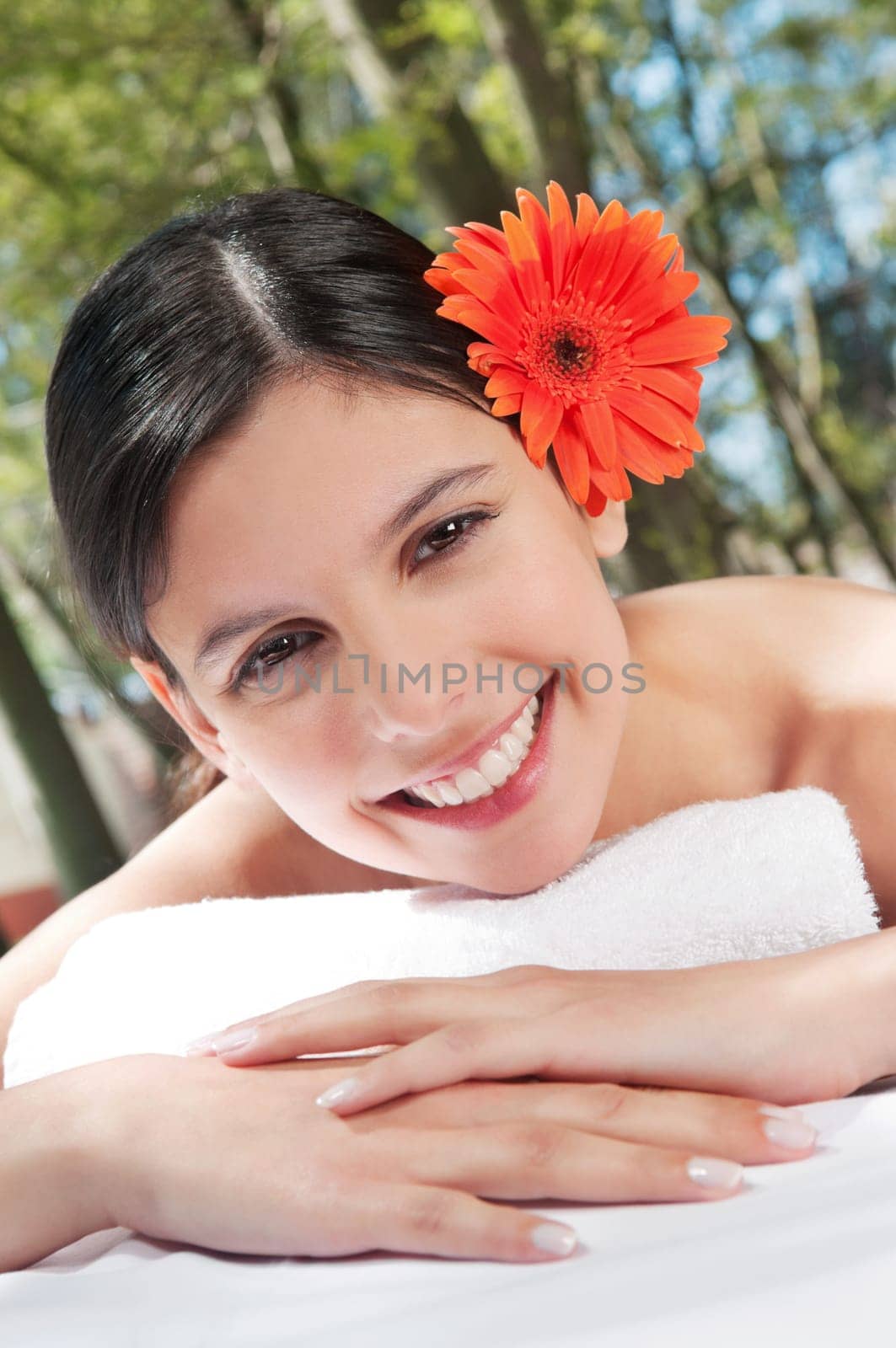 Portrait of a happy girl with flower in her hair
