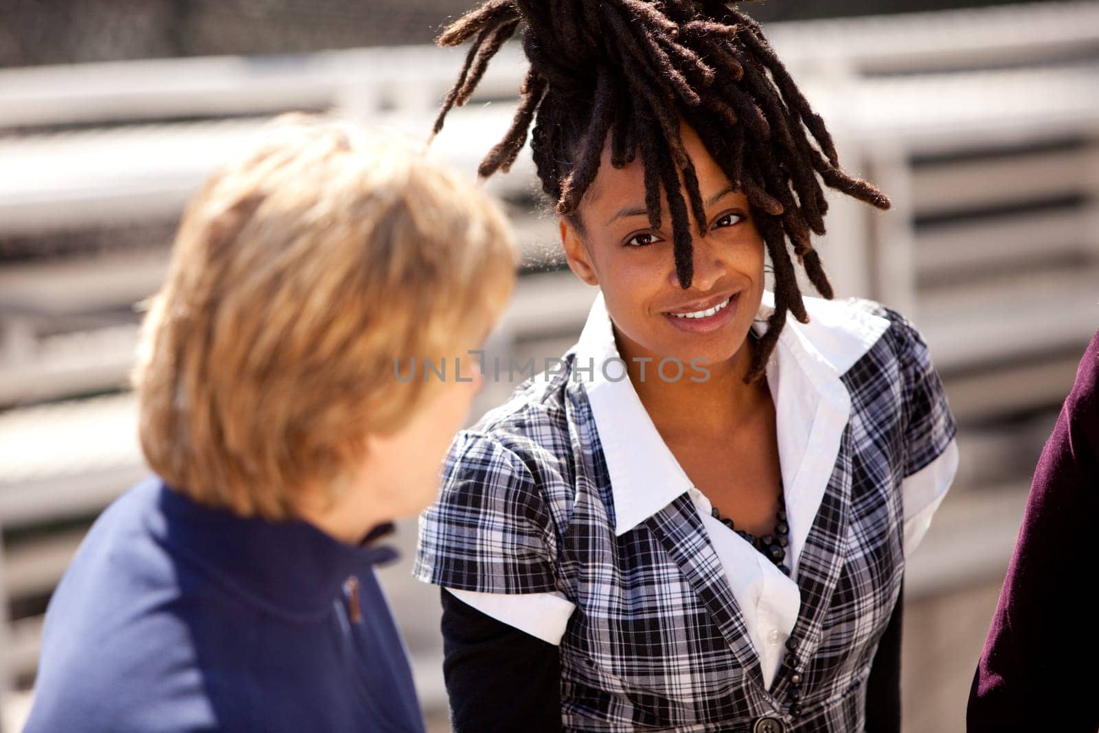 A casual portrait of a beautiful african american talking with friends