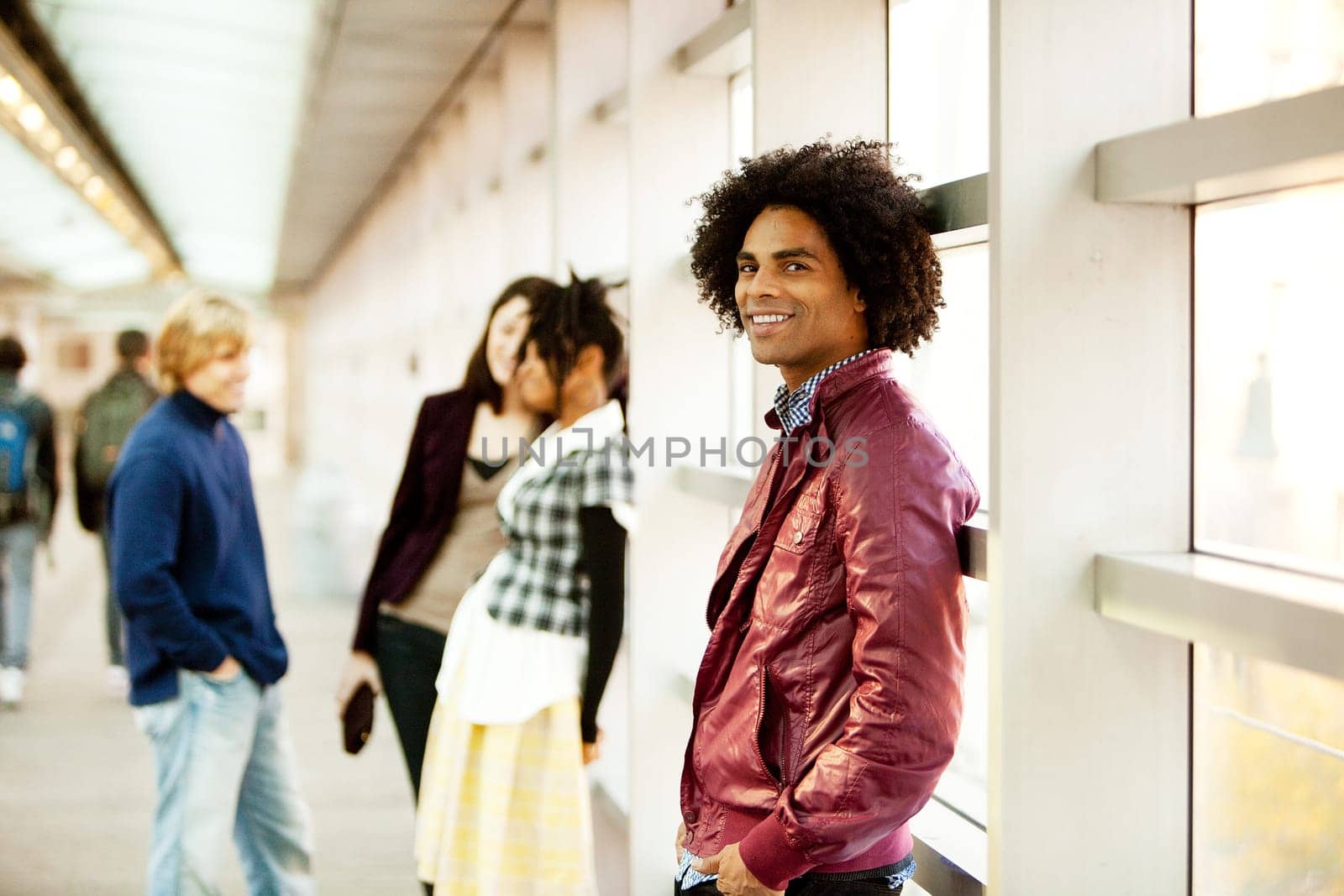 An African American male with friends talking in the background
