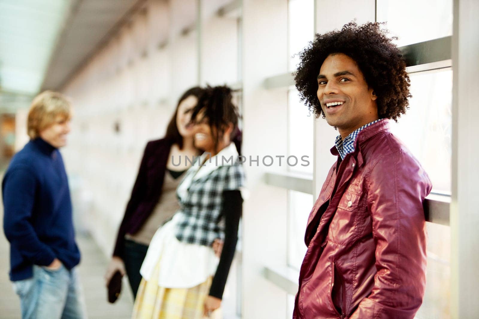 A young African American man with a group of people in the background