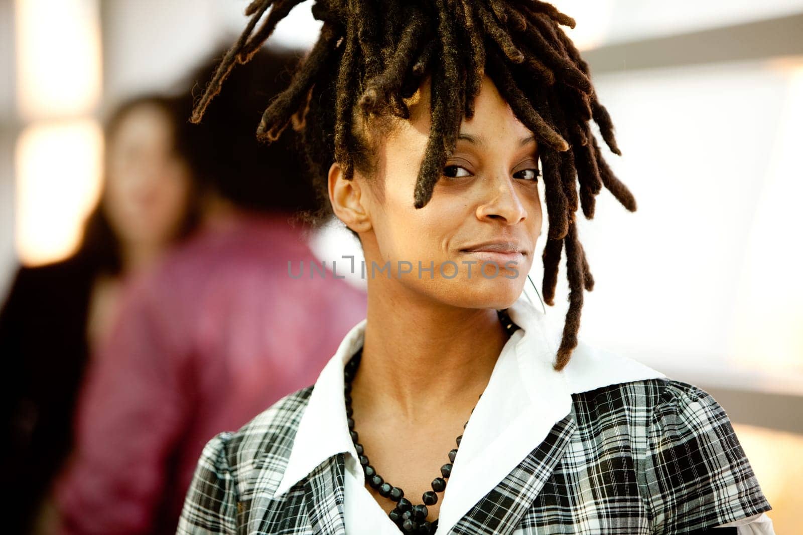 A beautiful African American woman with friends in background