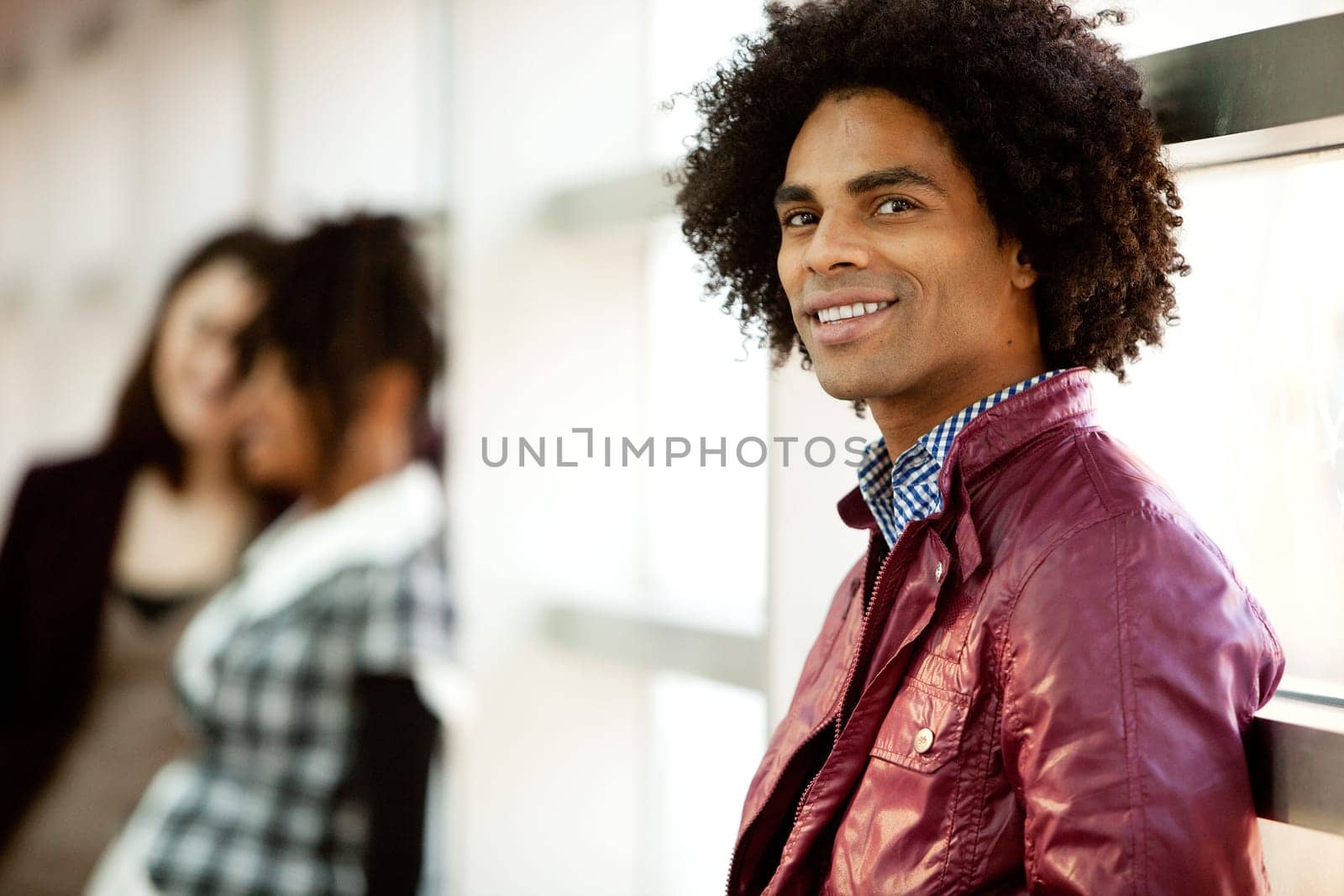 An African American male with two women talking in the background