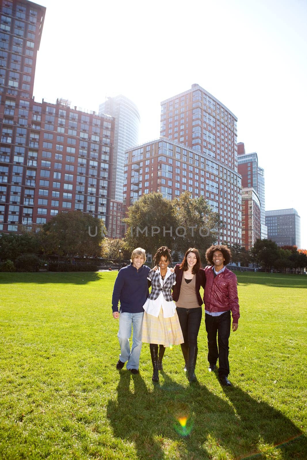 A group of college students in a park - shot against the sun with solar flare