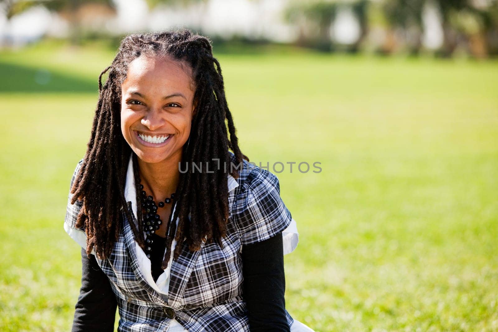 A beautiful African American woman isolated on grass