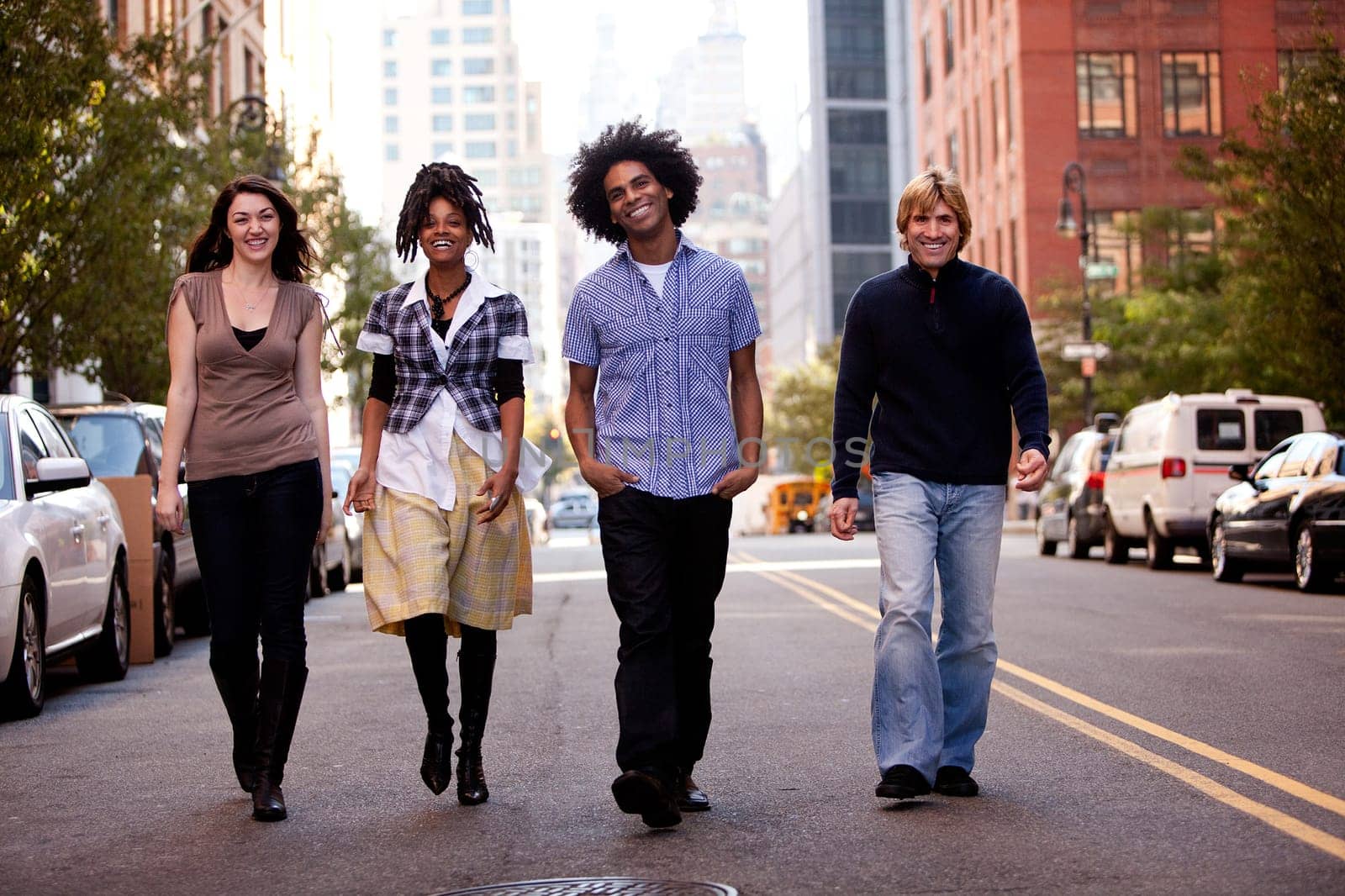 A group of friends on a street in a large city