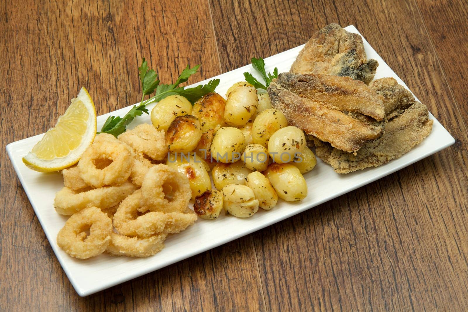 a dish with different fish fried and potate