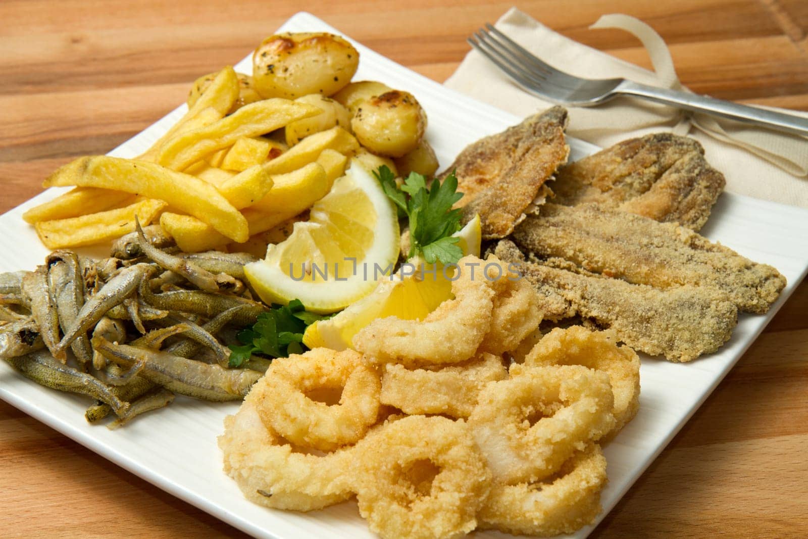 a dish with different fish fried and potate