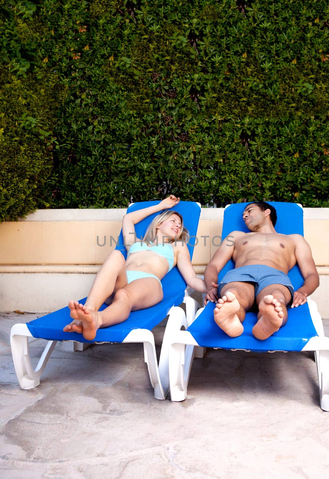 A couple relaxing at a hotel pool