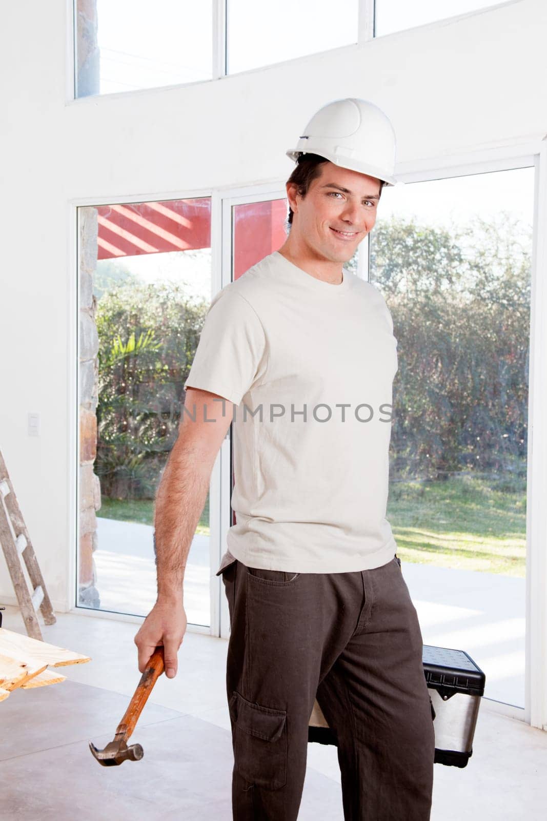 A portrait of a construction worker with a white helmet