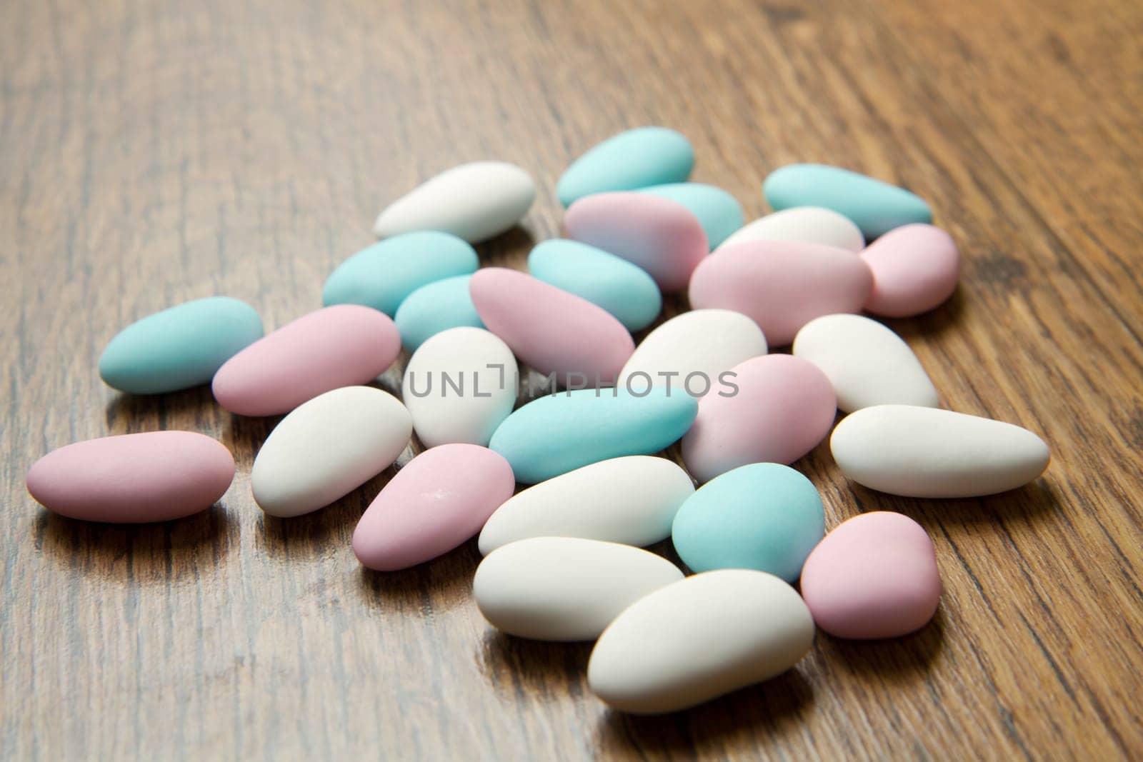 colored jordan almonds on wood background