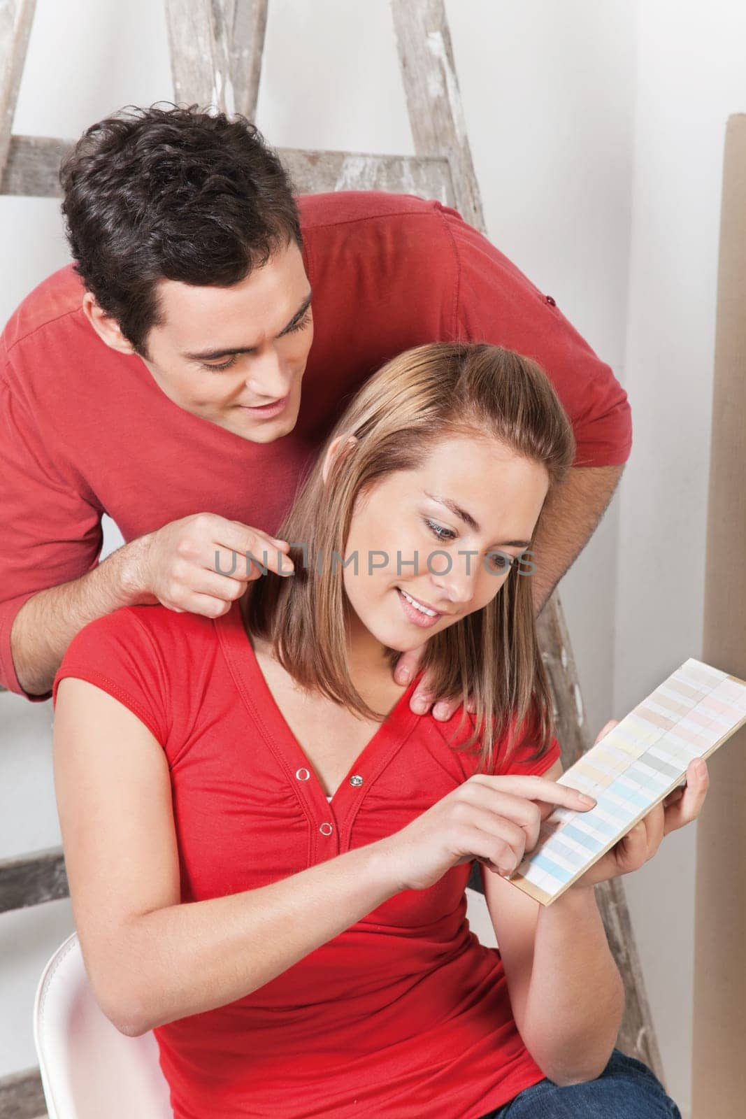 Happy couple pointing at color guide