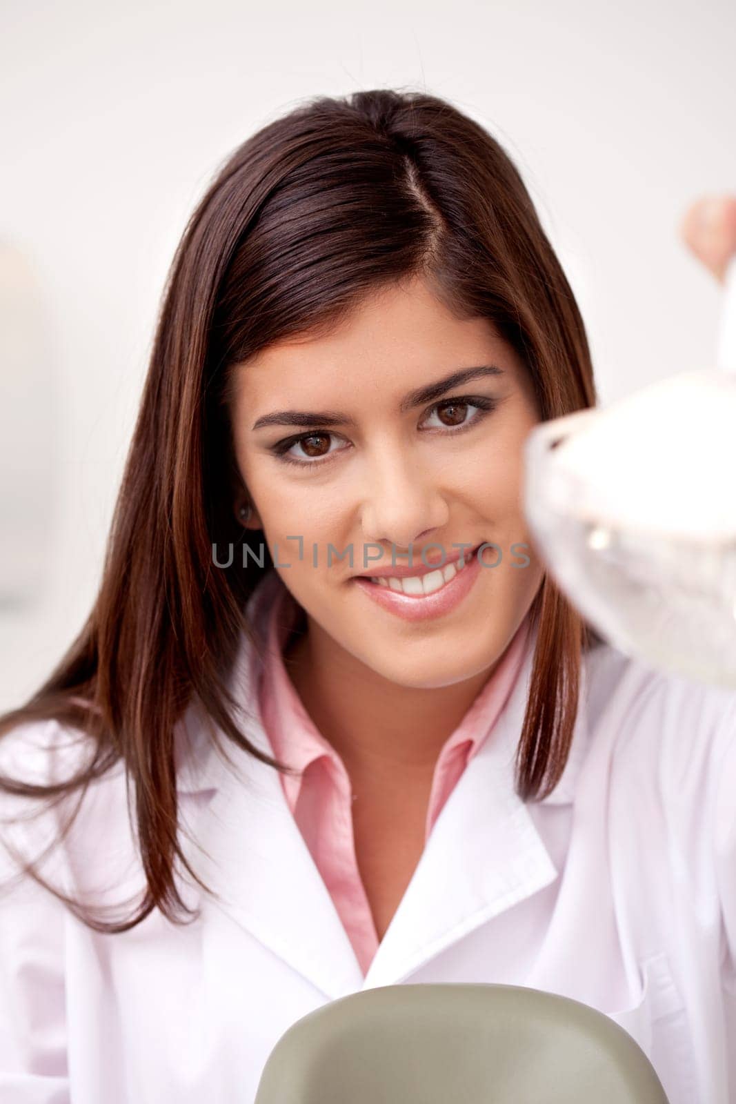 Portrait of an attractive young woman dentist looking at the camera