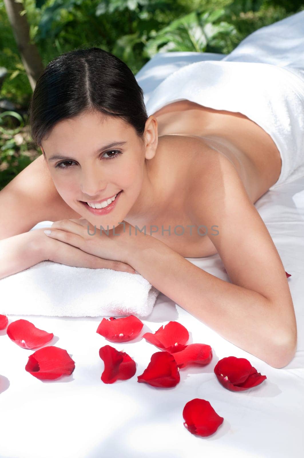 Smiling young woman relaxing at spa in a natural setting