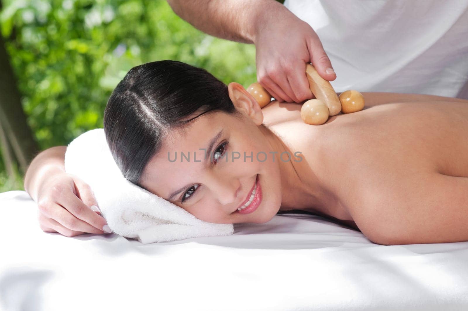 Beautiful young woman getting massage by a therapist