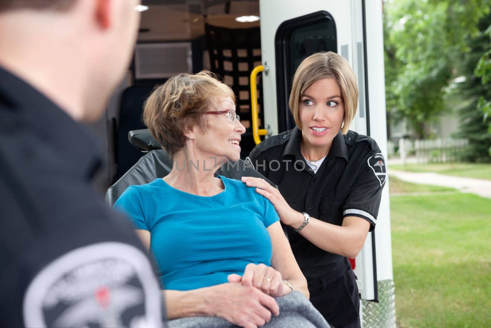 Lifestyle shot of an ambulance worker asking a patient a question