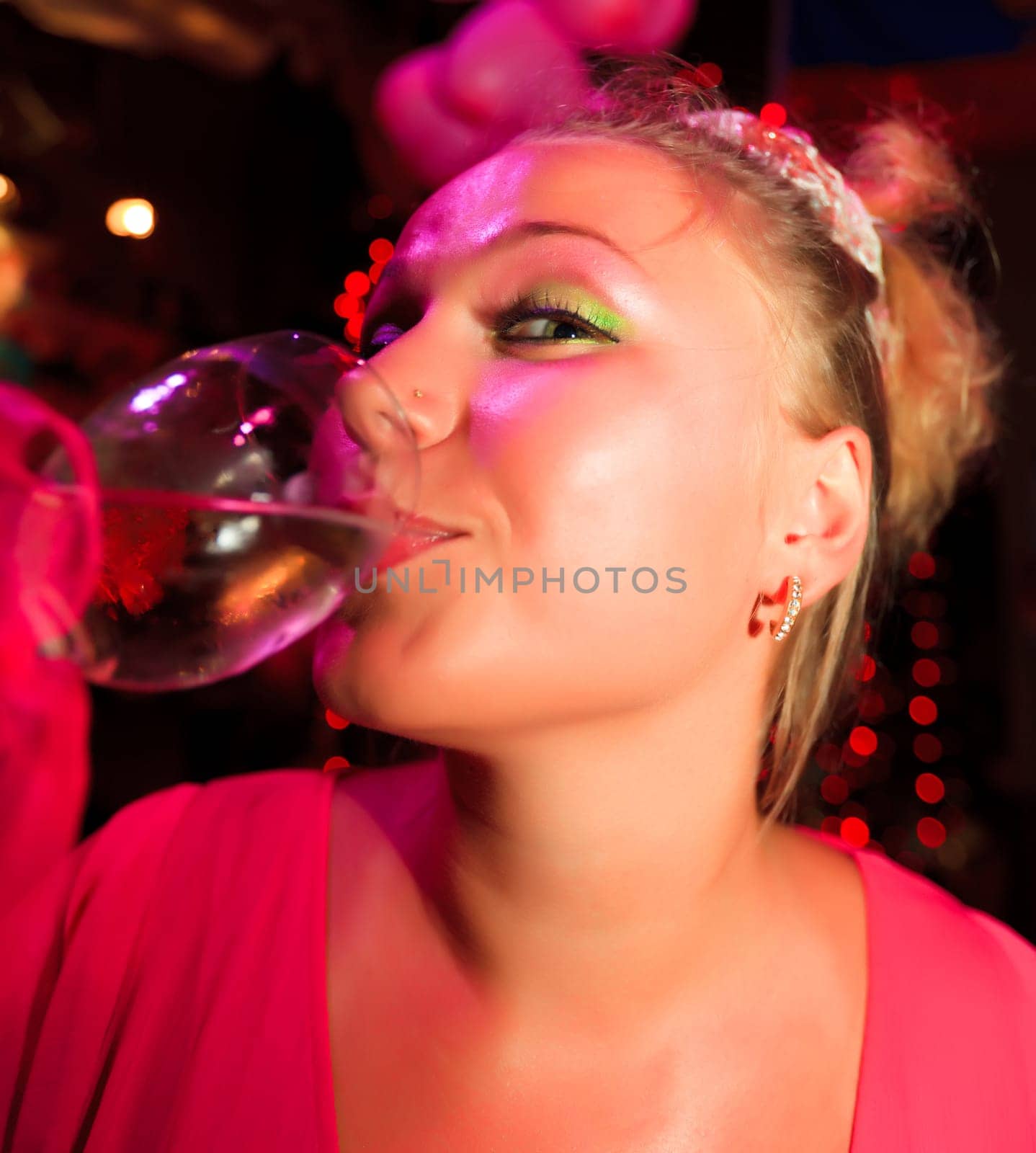 Young woman with glass of wine at party