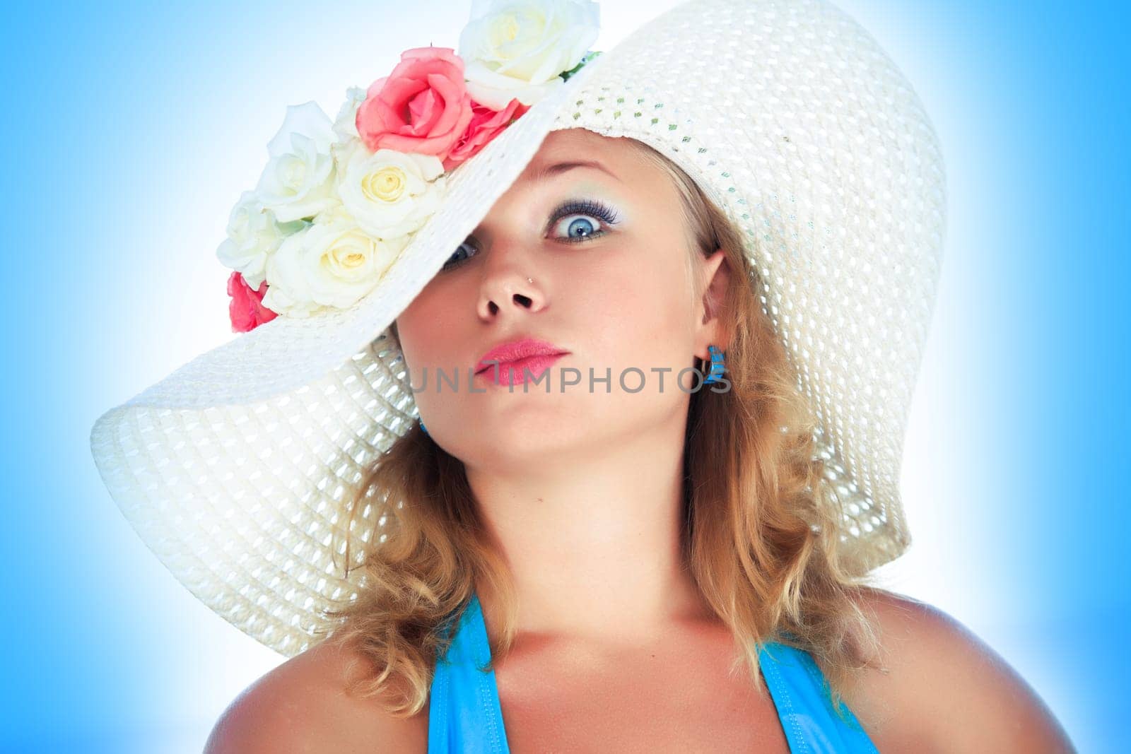 Funny woman as a doll in hatwith flowers