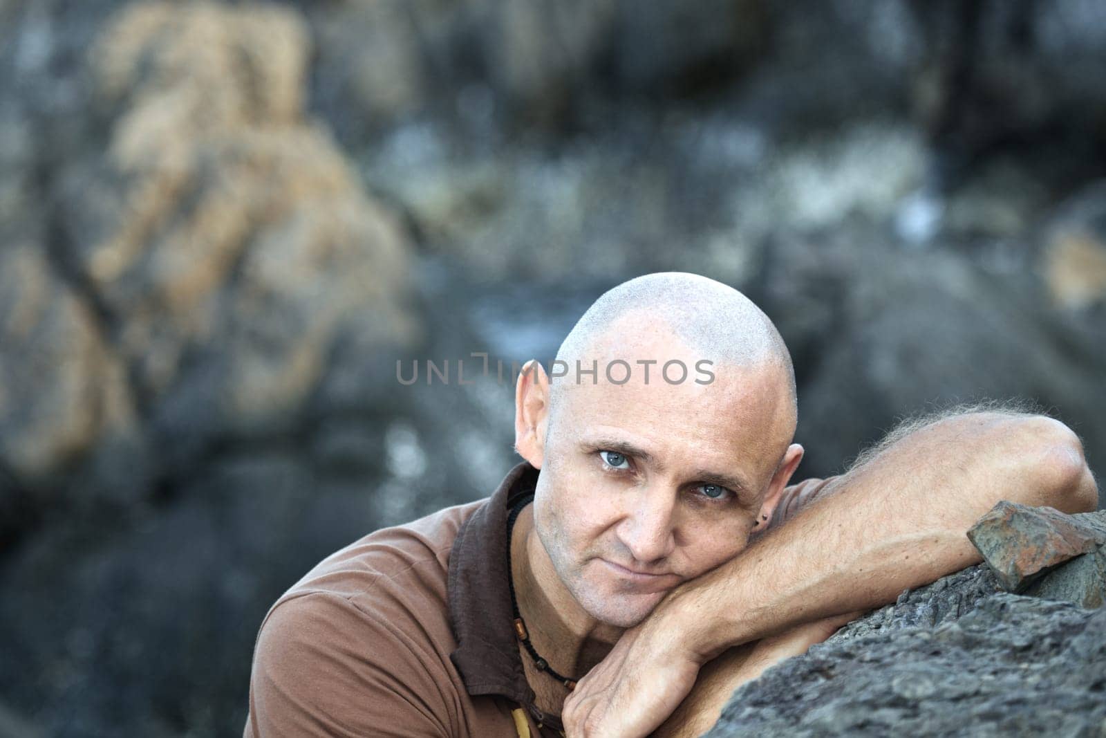 Outdoor man portrait at the rocky cape