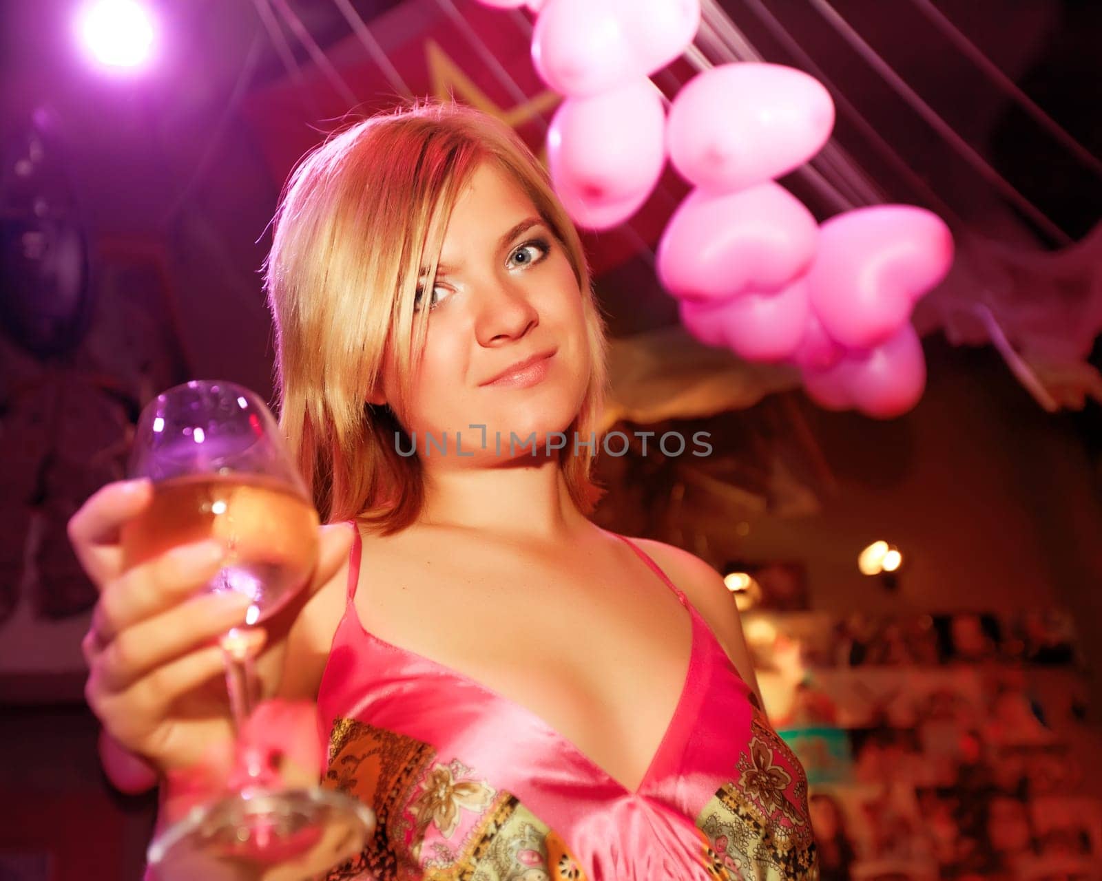 Young woman with glass of wine at party