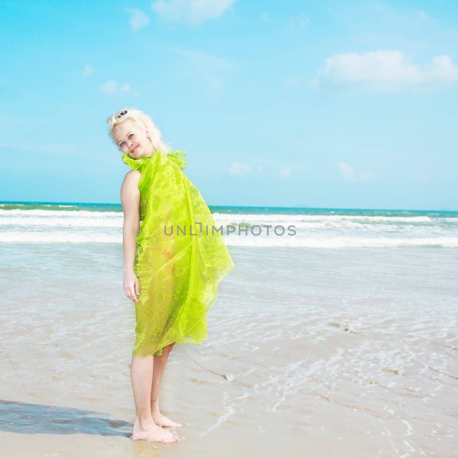 Young woman in green wrap at the  beach